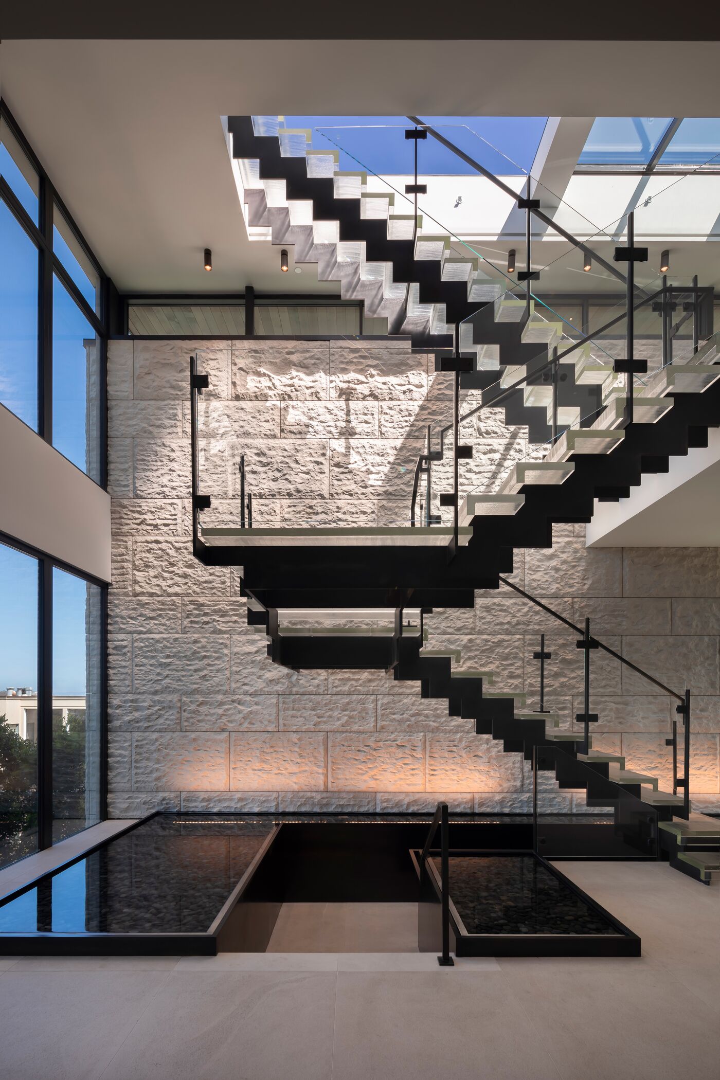 Floating staircase in daylight — Troon Pacific residence
