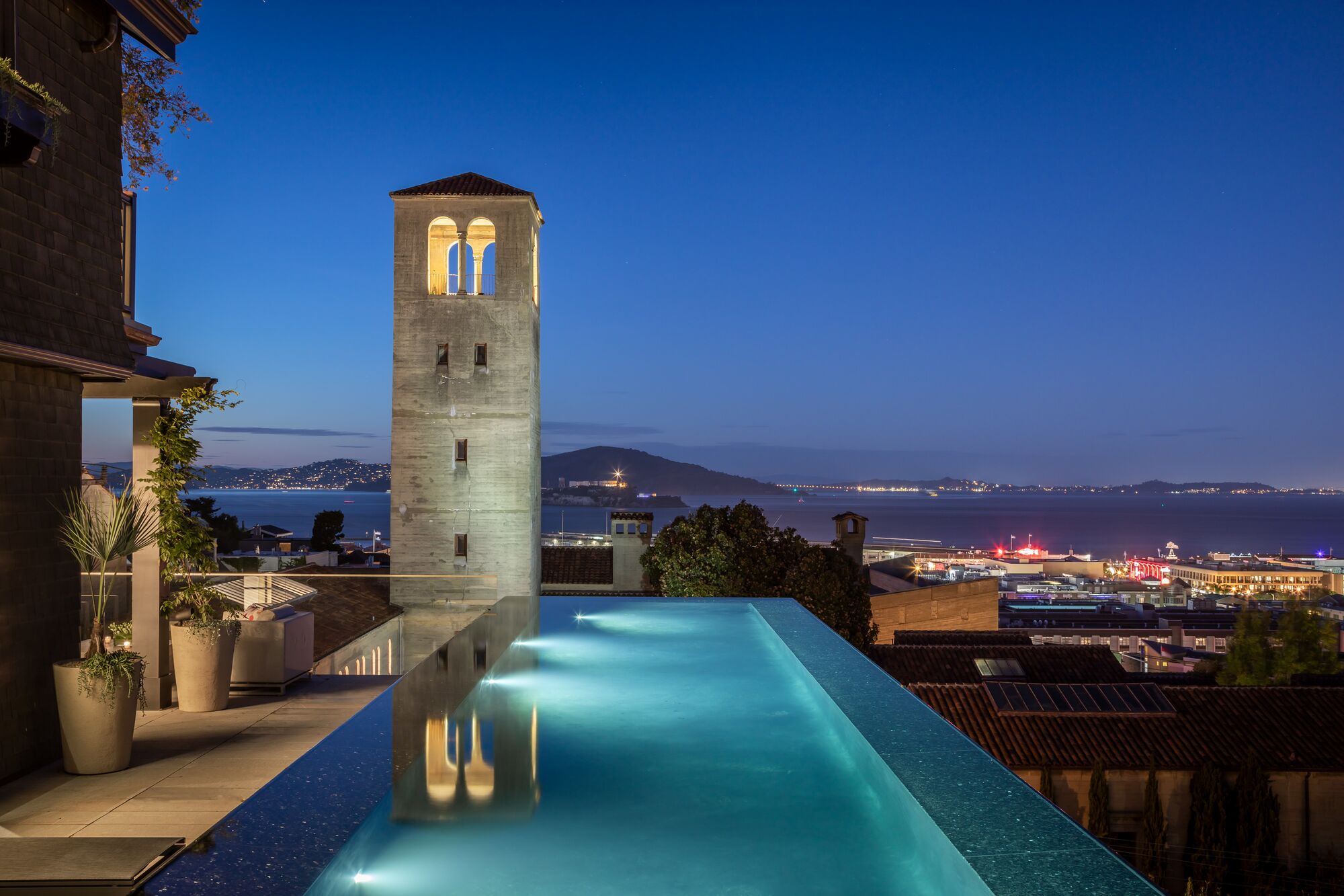Night pool with tower reflection — Troon Pacific residence